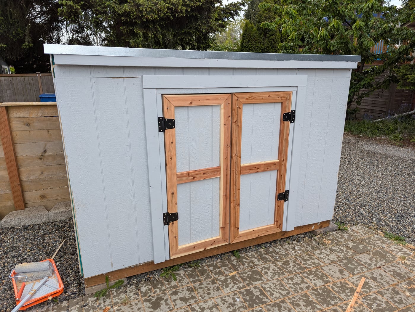 Shed painted with cedar trim, before hardware